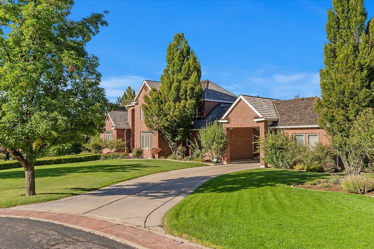 View of front facade with brick siding and a front lawn