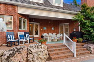 View of patio with a grill, outdoor dining space, and a wooden deck