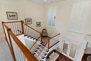 Staircase with french doors and plenty of natural light