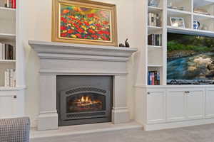Detailed view of a warm lit fireplace and carpet
