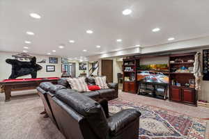 Living room featuring light carpet, billiards table, and recessed lighting