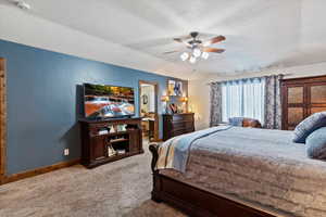 Carpeted bedroom with baseboards and ceiling fan