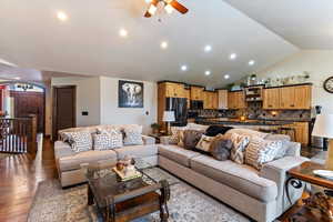 Living area with ceiling fan, vaulted ceiling, hardwood / wood-style flooring, and recessed lighting