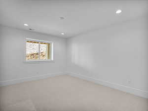 Spare room featuring carpet flooring and recessed lighting