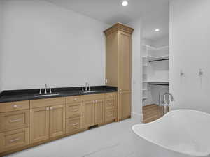 Bar area featuring recessed lighting, dark stone countertops, and light marble finish flooring