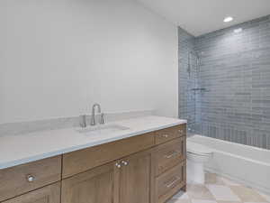 Bathroom with vanity,  shower combination, and recessed lighting