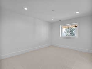 Empty room featuring carpet and recessed lighting