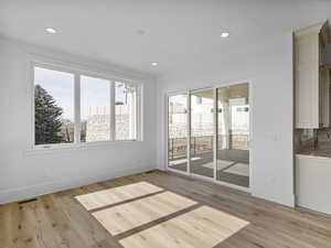 Empty room featuring light wood finished floors and recessed lighting