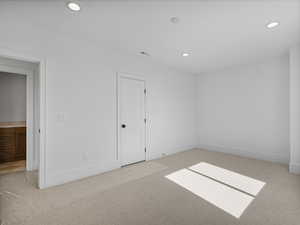 Unfurnished room featuring light colored carpet and recessed lighting