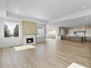 Unfurnished living room with a fireplace, recessed lighting, and light wood-style floors