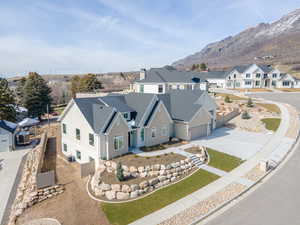 View of front of house with a residential view, driveway, and a mountain view
