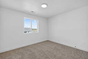 Unfurnished room featuring baseboards and carpet floors