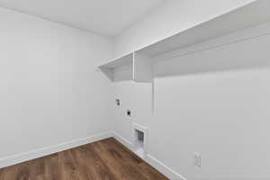 Laundry area with dark wood finished floors, washer hookup, and electric dryer hookup