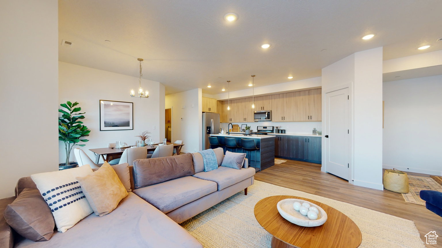 Living area featuring light wood finished floors and hanging lights