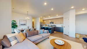 Living area featuring light wood finished floors and hanging lights