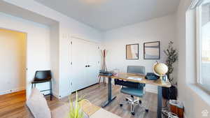 Home office with light wood-style floors