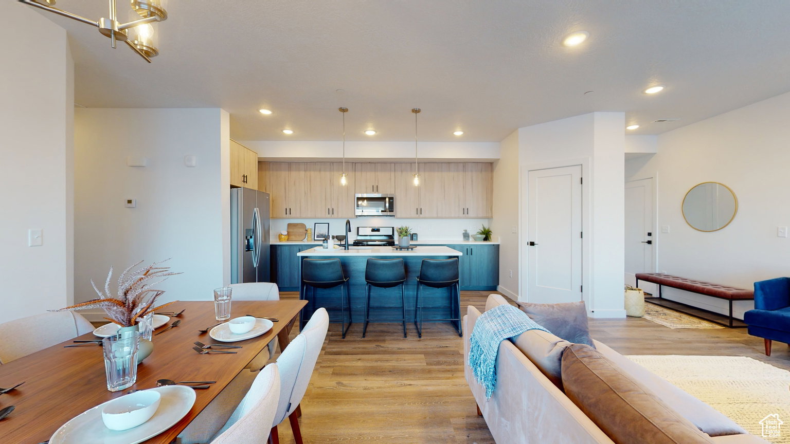 Dining room with light wood-style floors and recessed lighting