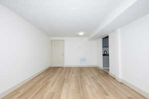 Spare room with light wood-style floors and baseboards