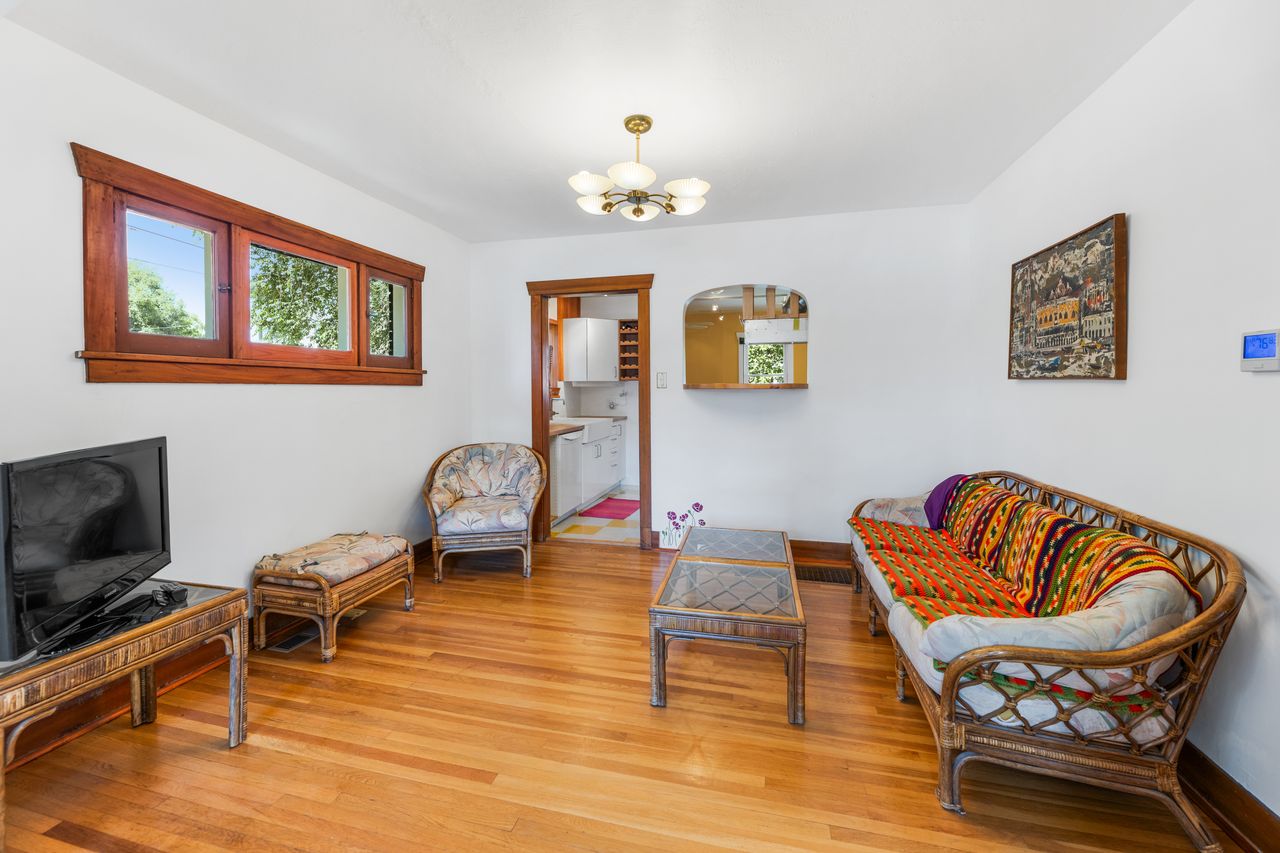 Living room featuring hanging lights and hardwood / wood-style flooring