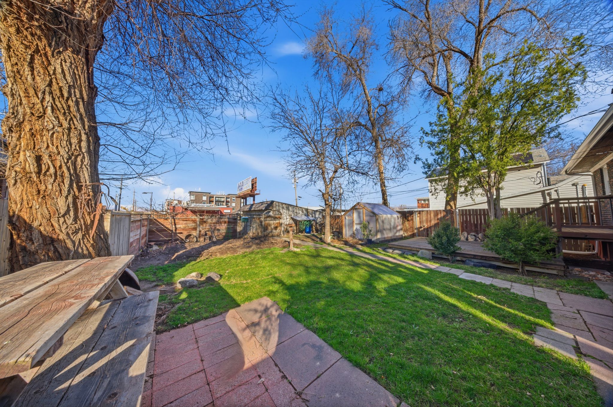 Fenced backyard with a deck and a shed