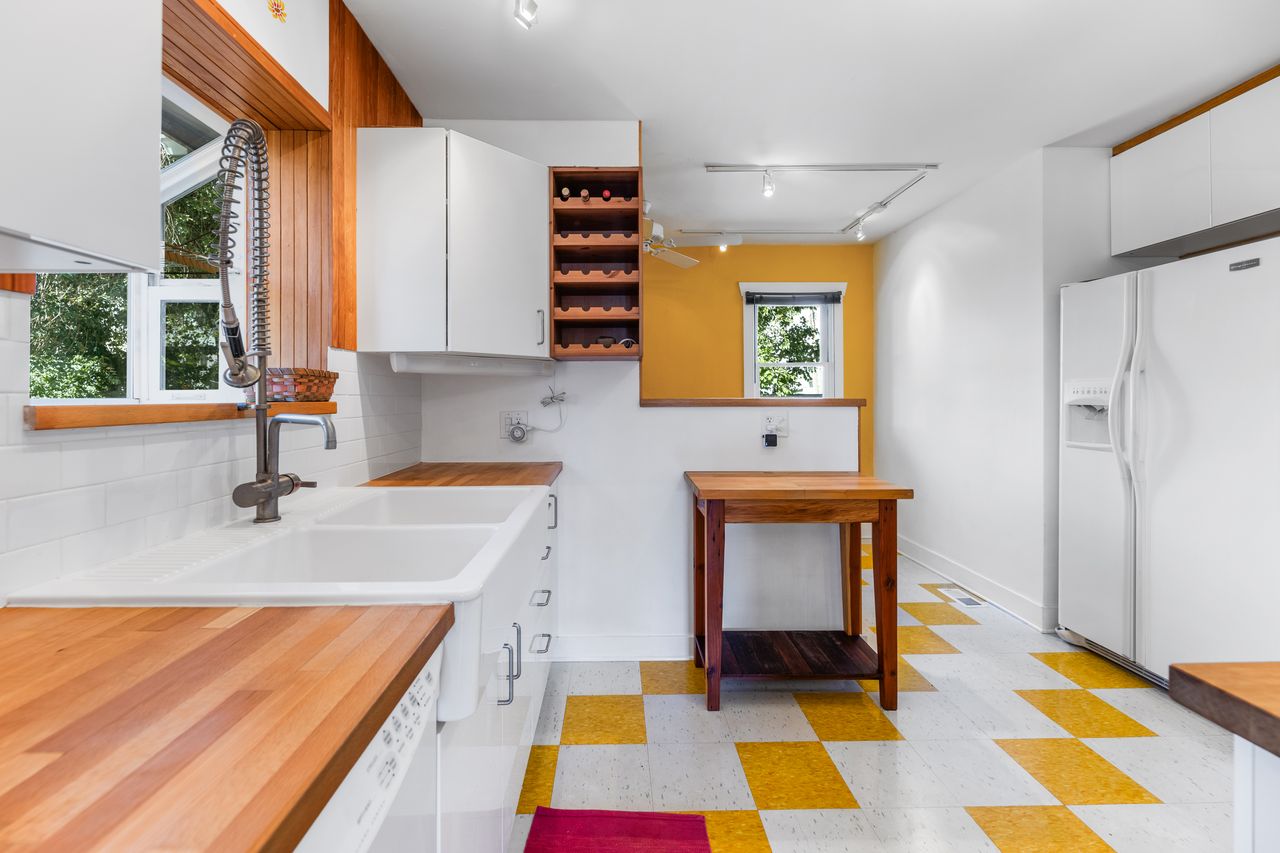 Kitchen with light flooring, white appliances, track lighting, white cabinetry, and open shelves