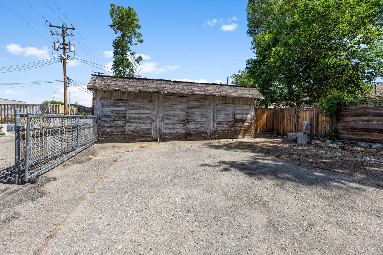 View of outbuilding with a gate