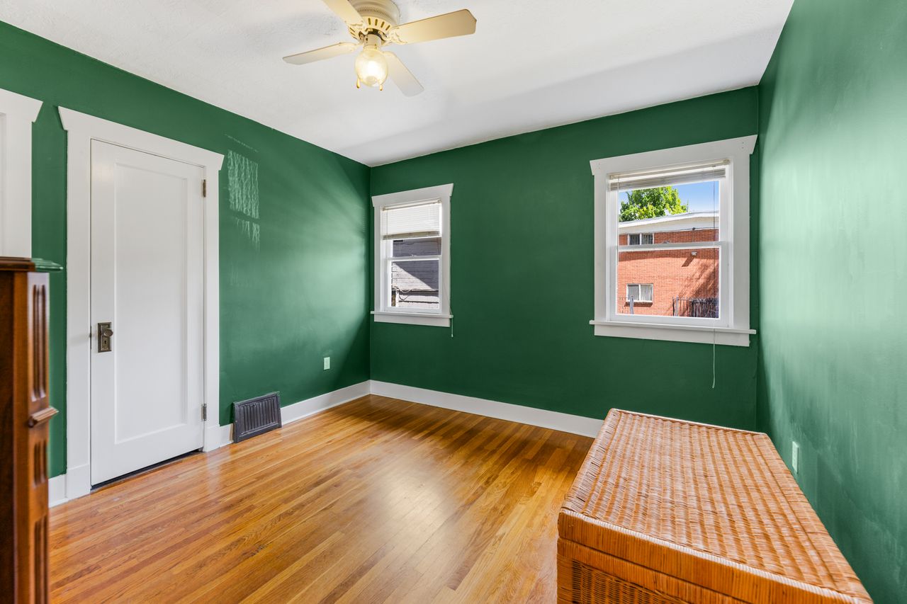 Unfurnished bedroom with multiple windows, light wood finished floors, and ceiling fan