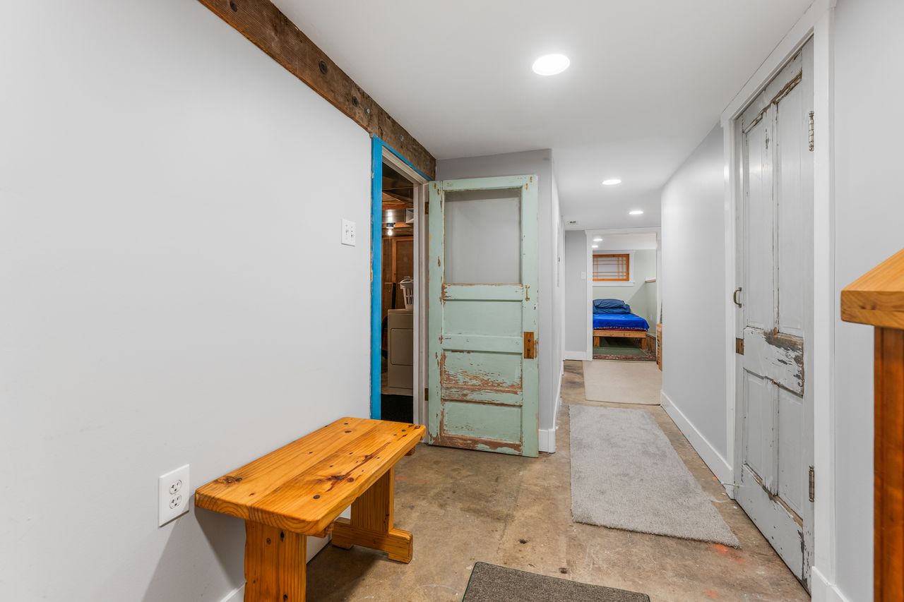 Hallway featuring unfinished concrete floors and recessed lighting