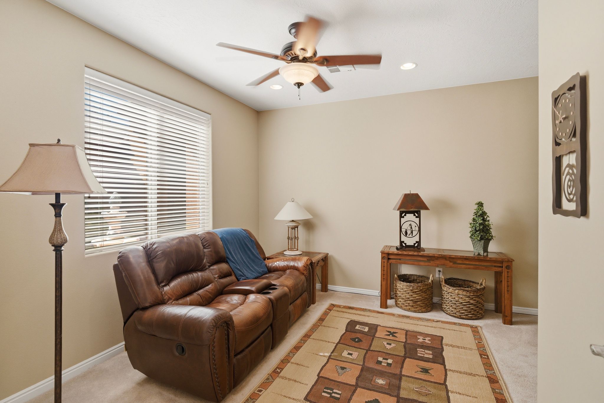 Sitting room with light colored carpet, a ceiling fan, and recessed lighting