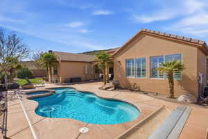 Combined pool / hot tub featuring a patio area