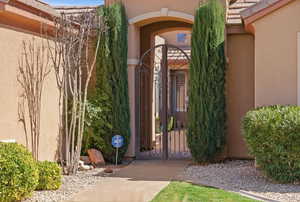 Doorway to property with a gate and stucco siding