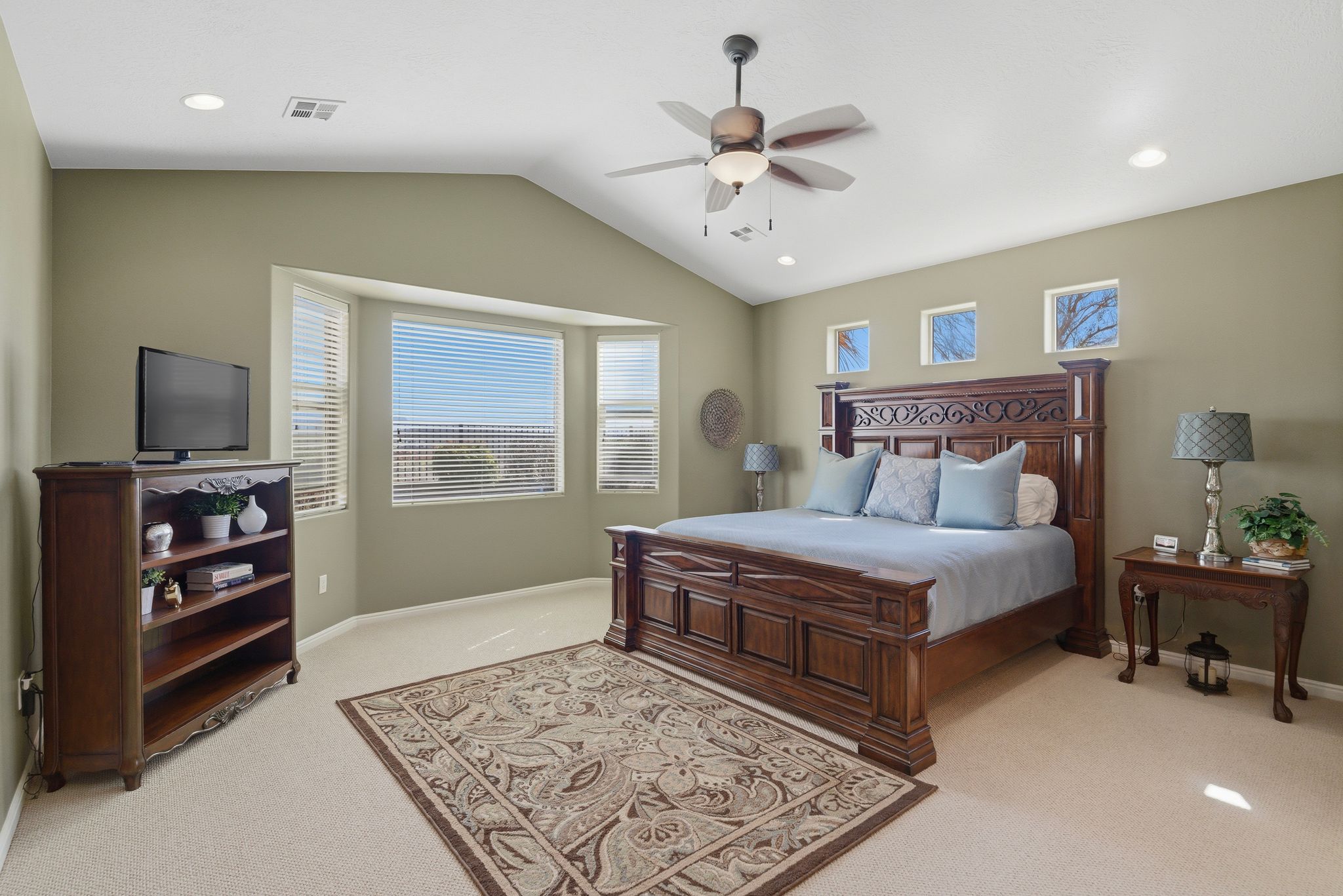 Bedroom with light carpet, recessed lighting, and a ceiling fan