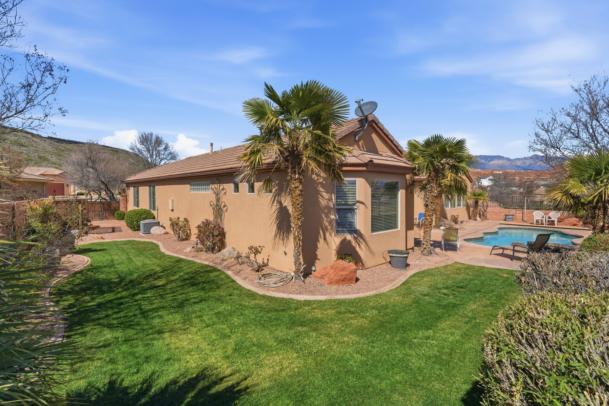 Back of house with a patio, stucco siding, and a mountain view