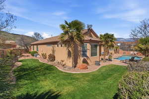 Back of house with a patio, stucco siding, and a mountain view