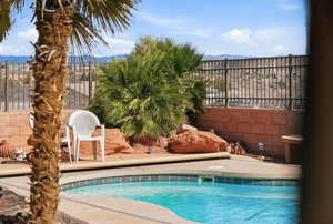 View of pool featuring patio surround and a mountain view
