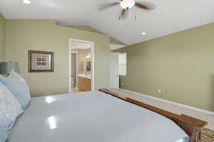 Bedroom with lofted ceiling, a ceiling fan, recessed lighting, and ensuite bathroom