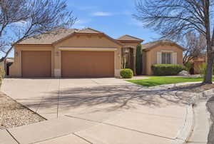Mediterranean / spanish-style house featuring driveway, stucco siding, a garage, a tiled roof, and a front lawn