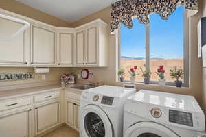 Laundry area featuring cabinet space and washer and dryer
