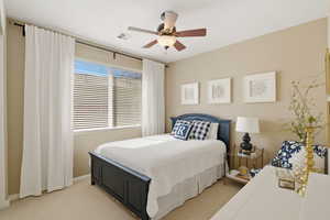 Bedroom featuring ceiling fan and light carpet
