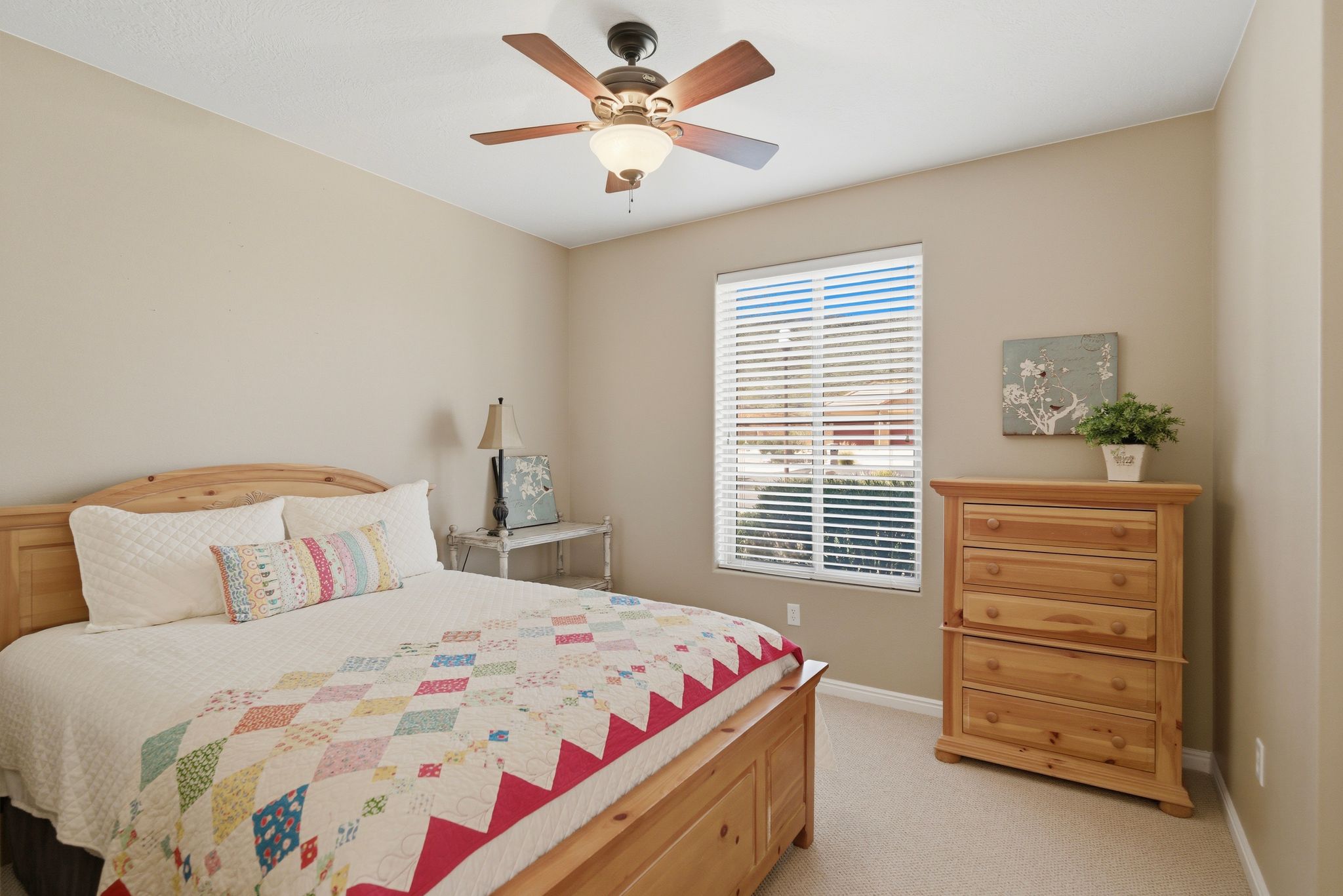 Bedroom with light colored carpet and ceiling fan
