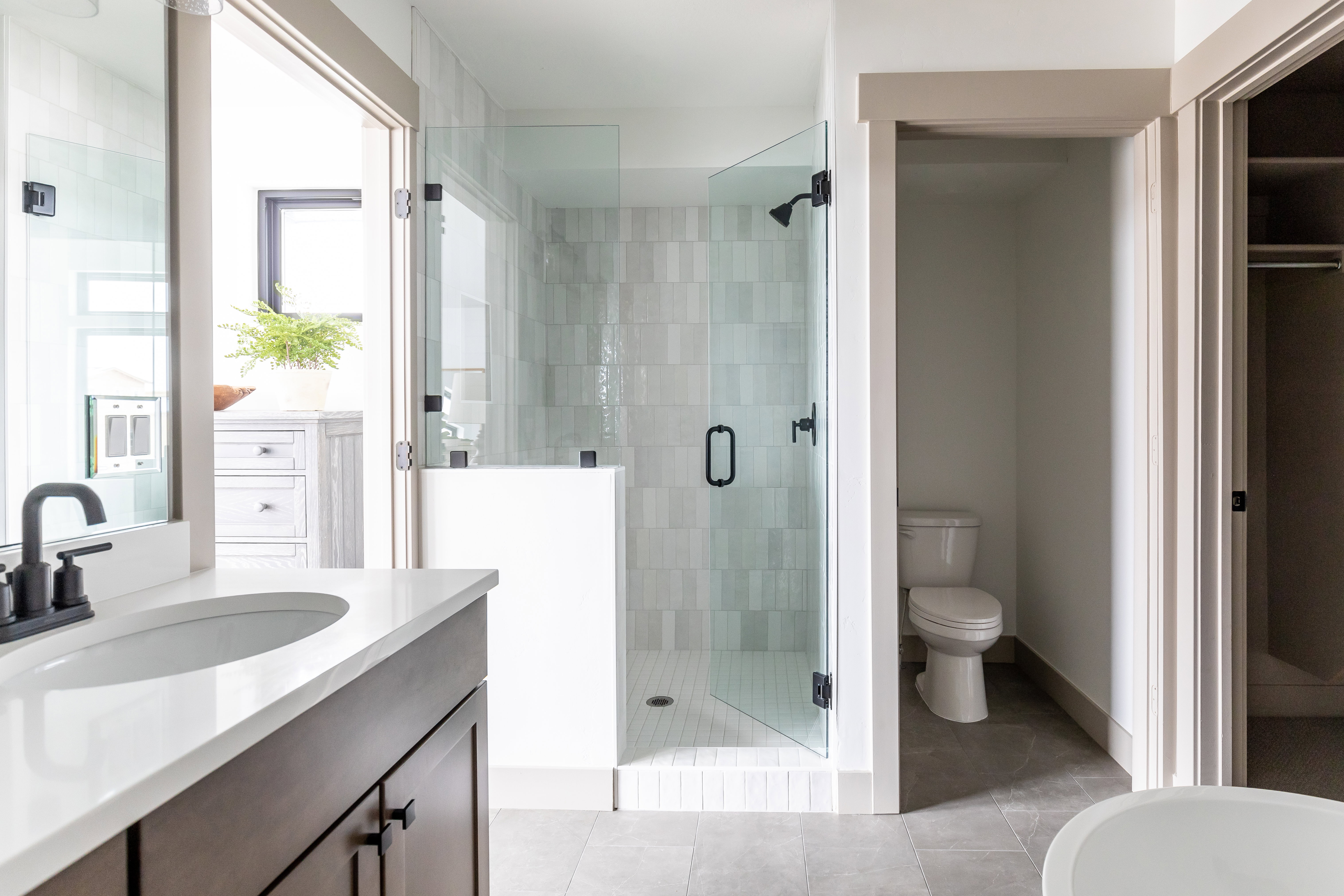 Bathroom with vanity, a shower stall, and light tile patterned flooring