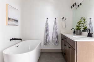 Full bath with double vanity and a freestanding tub