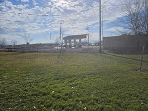 View of green lawn with a patio