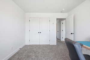 Bedroom with carpet and own closet.