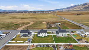 Overview of rural landscape featuring a mountainous background and nearby suburban area