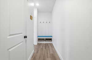 Mudroom featuring baseboards and light wood-style flooring