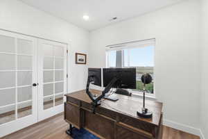 Office area featuring light wood finished floors and french doors