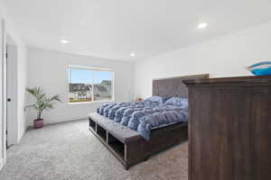 Carpeted bedroom with baseboards and recessed lighting