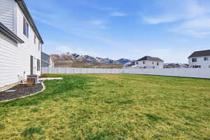 Fenced backyard featuring a residential view, a patio area, and a mountain view