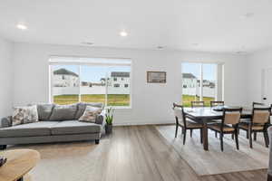 Living area featuring light wood finished floors and recessed lighting